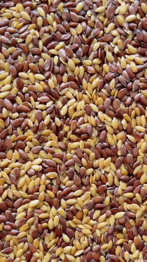 Camera flyover above raw flax seeds macro texture. Vertical Stock Footage 336506971