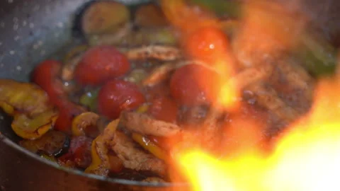 Camera Focus Shift from Campfire Flames to Cooking Food 動画素材 310826414