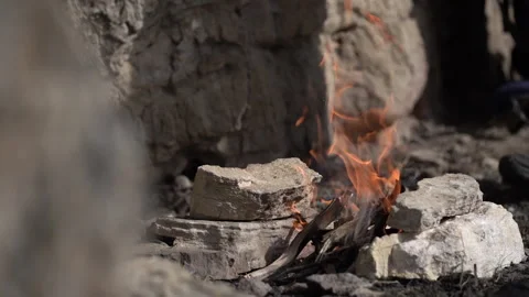 Camera Focus Shifting from Stone to Cooking Over Campfire 動画素材 318845880
