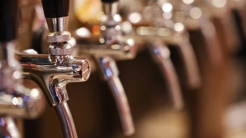 Camera focuses on stainless beer taps in modern bar interior Stock Footage 333682194