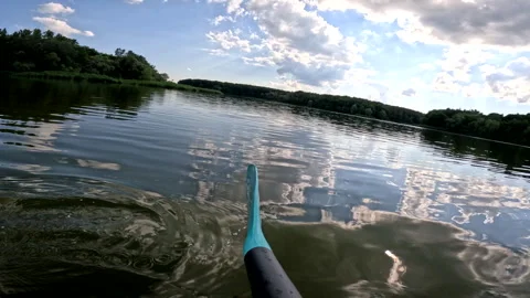 Camera follow the paddle in the lake Stock Footage 246525630