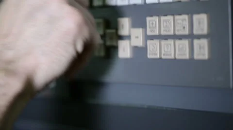 Camera following CNC operator's hands inserting parameters to milling machine Stock Footage 49002124