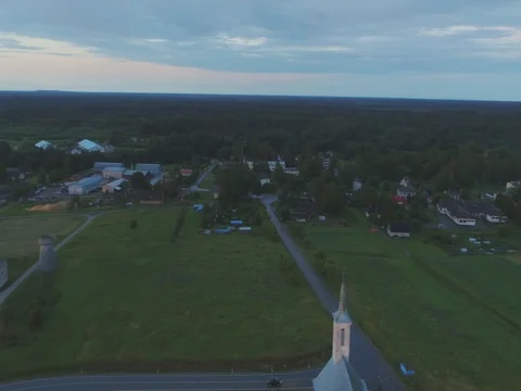 Camera follows black car, on the road at dusk. Aerial footage Stock Footage