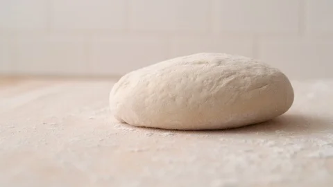 Camera follows a dough falling on a table. Slow Motion. Stock Footage 128967126