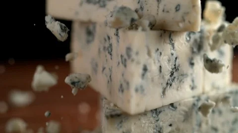 Camera follows grating blue cheese. Slow Motion. Stock Footage 84939571