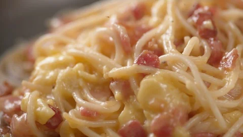 Camera follows grinding pepper over carbonara pasta. Slow Motion. Stock Footage 104458542