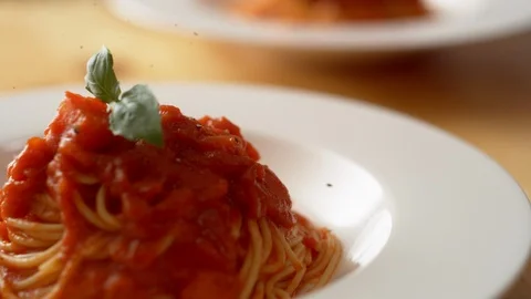 Camera follows grinding pepper on tomato sauce spaghetti. Slow Motion. Stock Footage 104457638