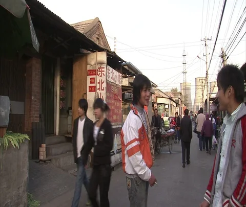 Camera follows man on three wheeled cargo bike though village street Stock-Footage 86745558