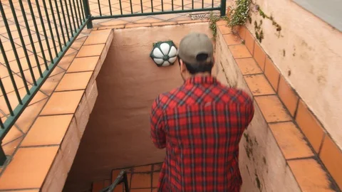 Camera Follows Man Walking Down Stairs to Garage Stock Footage 107898434