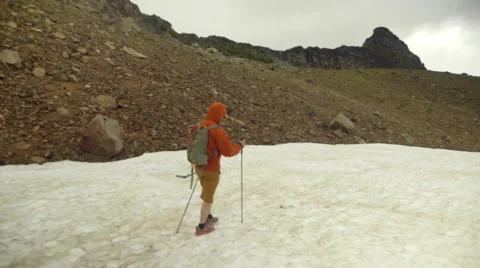 Camera follows a man walking on snow Stock Footage 59521804