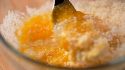 Camera follows mixing eggs with bread crumb in a bowl. Slow Motion. Video stock 104457812