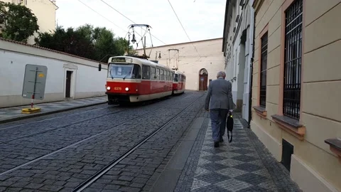 The camera follows an old man down a narrow street in old Prague. Stock Footage 168495803