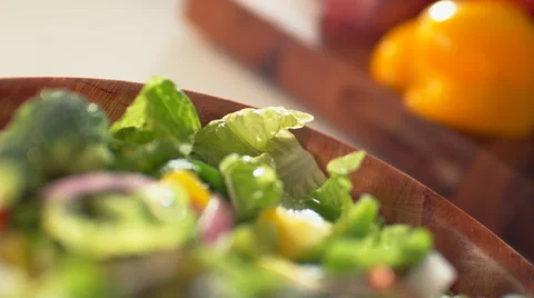 Camera follows parmesan cheese being put on salad. 4K 30fps. Slow Motion. Stock Footage 55533151