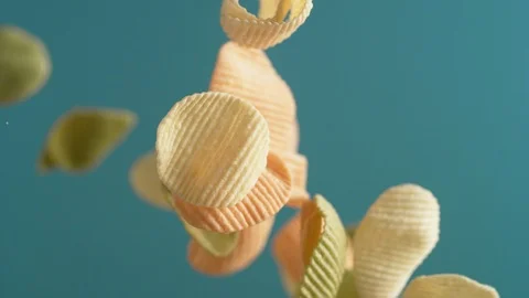 Camera follows potato chips flying in the air. Slow Motion. Stock Footage 121484647