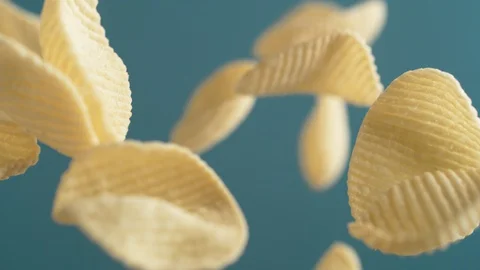 Camera follows potato chips flying in the air. Slow Motion. Stock Footage 128959637