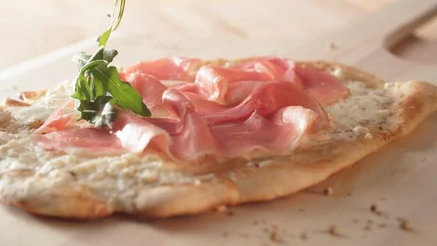 Camera follows putting fresh arugula leaves on a white pizza. Slow Motion. Stock Footage 121494745
