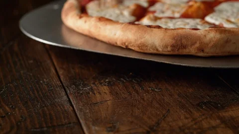 Camera follows putting a fresh basil leaf on a pizza. Slow Motion. Stock Footage 128972605