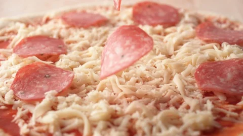 Camera follows putting sliced black olives on a pizza dough. Slow Motion. Video stock 121494076