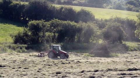 Camera follows Red Tractor moving through picturesque rural European Landscape Stock Footage 39542130