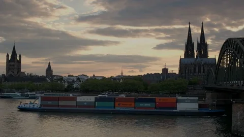 Camera follows river barge under Hohenzollernbrucke with Cologne Cathedral Stock Footage 90850004