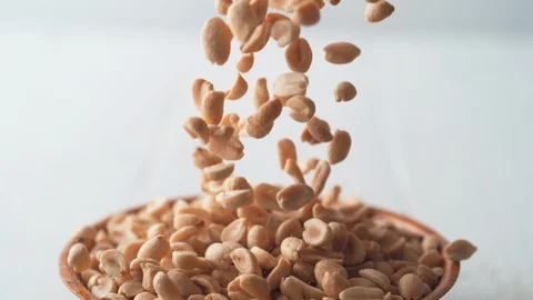 Camera follows salted peanuts falling. Slow Motion. Stock Footage 89807952