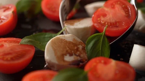 Camera follows scooping tomato and mozzarella cheese salad. Slow Motion. Stock Footage 104459733