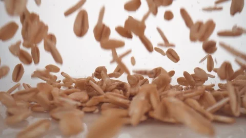 Camera follows sliced peanuts falling on surface. Slow Motion. Stock Footage 128768661