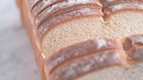 Camera follows sliced white bread. Slow Motion. Stock Footage 84937546