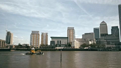 Camera follows small dredger on the River Thames from Rotherhithe, London Stock Footage 182322435