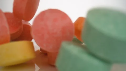 Camera follows smarties falling on surface. Slow Motion. Stock Footage 128767684