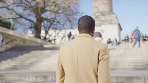 Camera follows a smartly dressed man as he walks up some stairs, in slow motion Video stock 122241984