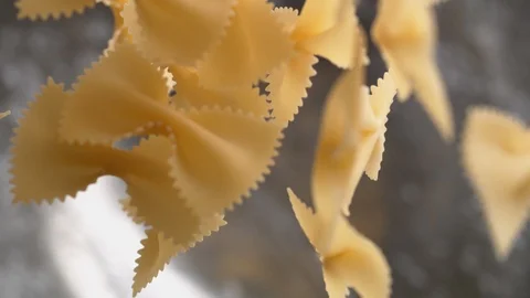 Camera follows throwing farfalle pasta into water. Slow Motion. Stock Footage 95941362