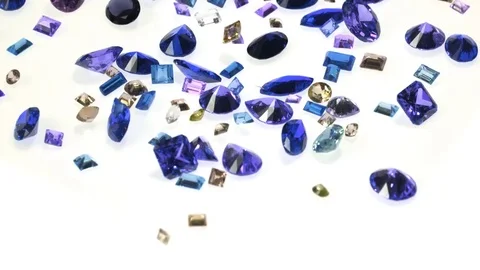 Camera follows various types of gemstones falling. Slow Motion. Stock Footage 72871393