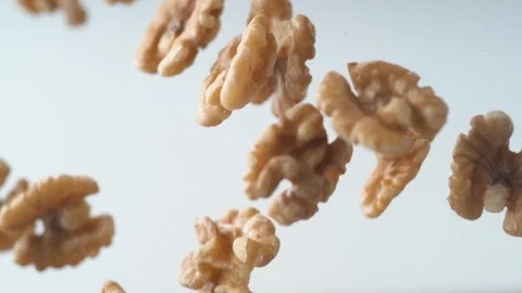 Camera follows walnuts in shell rolling on the table. Slow Motion. Stock Footage 89603937