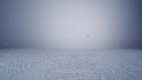 Camera follows water drop and ripple on surface. Slow Motion. Stock Footage 128769892