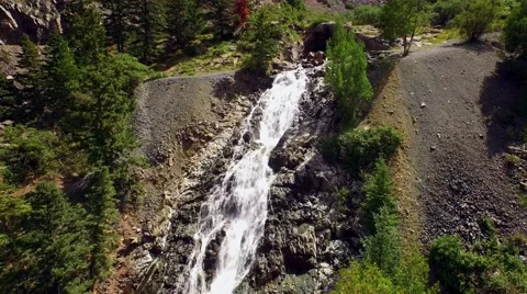 Camera follows a waterfall down from top to bottom. Stock Footage 53338415