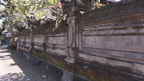 Camera footage along of the temple wall in asian city Stock Footage 108461330
