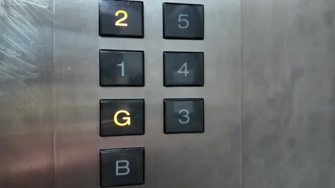 Camera footage of elevator button panel with glowing G Stock Footage 325560563