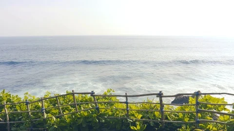 Camera footage of the ocean waves through the green coast Stock Footage 98567726