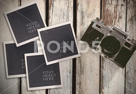 Camera with four photos on wooden table PSD-Vorlage