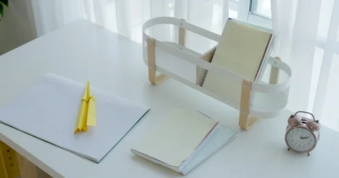 Camera gently glides across child study desk with paper, pencil, toy chair, and Stock-Footage 335763948