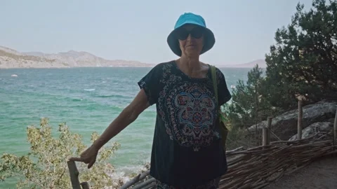 Camera getting closer to Happy senior lady standing on hiking trail Stock Footage 196297486