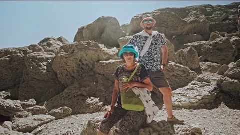 Camera getting closer to senior lady and adult son standing on hiking trail Video stock 196297514