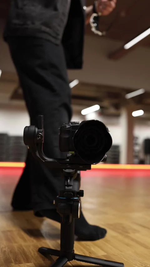Camera on gimbal dancer in background Stock Footage 332116697