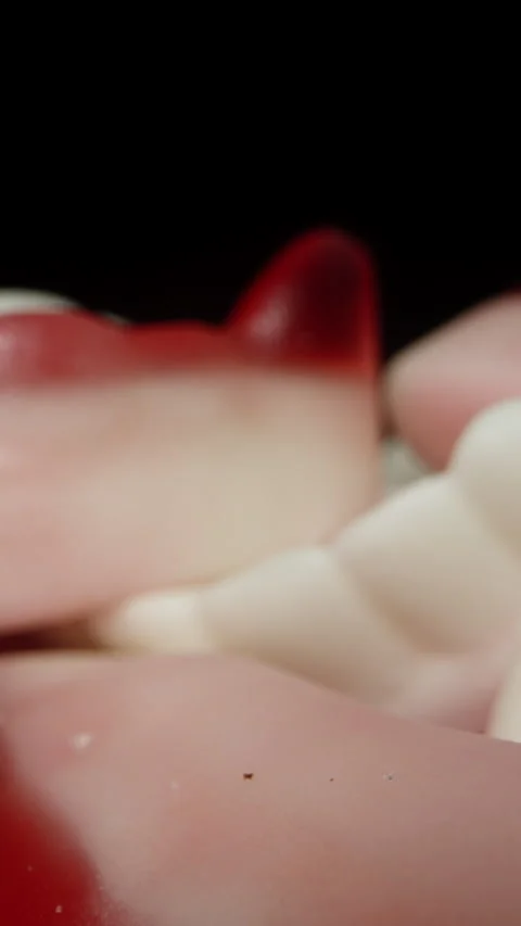 The camera glides across the chewy gummy candies shaped like teeth and vampire f Stock Footage 249582727