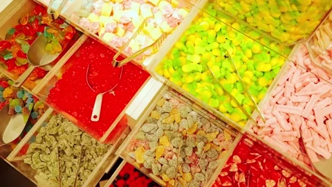 Camera glides over candy shop paradise, symbol of sugar addiction risk Stock Footage 323084706