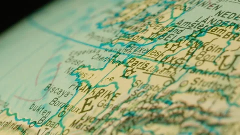 The camera glides over Europe on an old globe. Paris, London Stock Footage 145759213