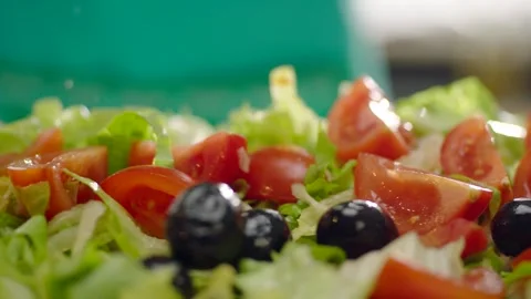 Camera Glides Over Fresh Lettuce Salad with Tomatoes and Black Olives 4K Vídeos de archivo 347364142