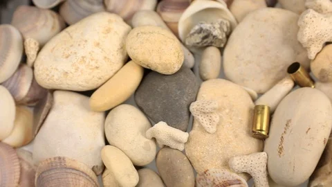 The camera glides over the pistol shells that fall Stock Footage 113823453