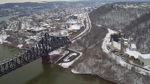 Camera glides over a train bridge to reveal a midwestern town in winter Stock Footage 71149856